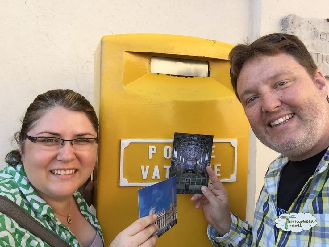 Vanessa and Ryan pose with post cards in front of a Vatican City yellow post box.Picture