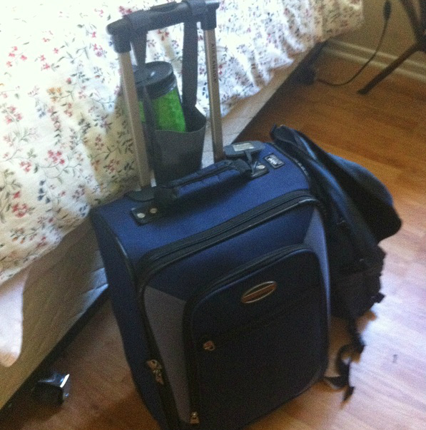 Blue suitcase packed and ready to go
