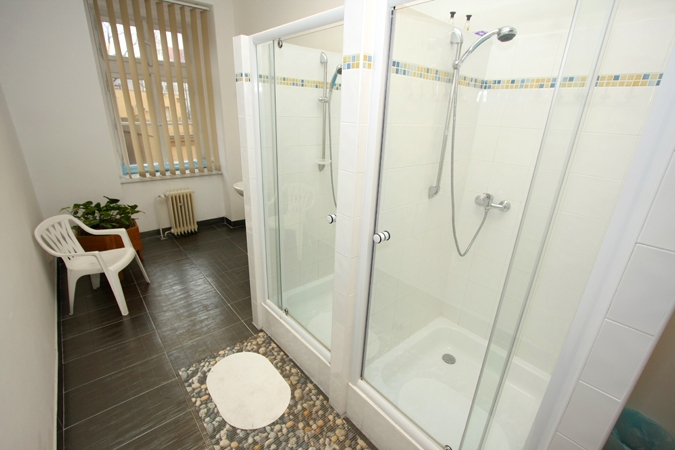 Bathroom with two shower stalls, both with glass doorsPicture