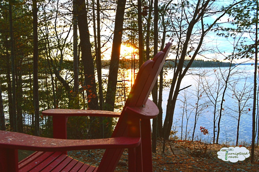 Red chair by lake Cozy microadventures for Ottawa travellers by TurnipseedTravel.com