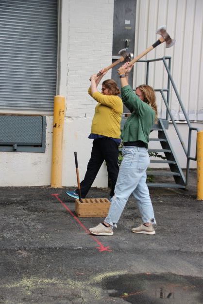 Vanessa and a friend get ready to throw their axes