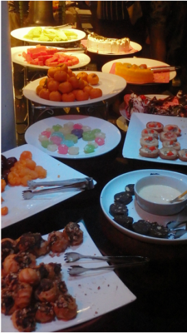 A number of buffet trays filled with sweets