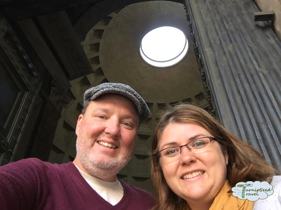 Selfie of Ryan and Vanessa in the Pantheon, with the round ceiling window above themPicture