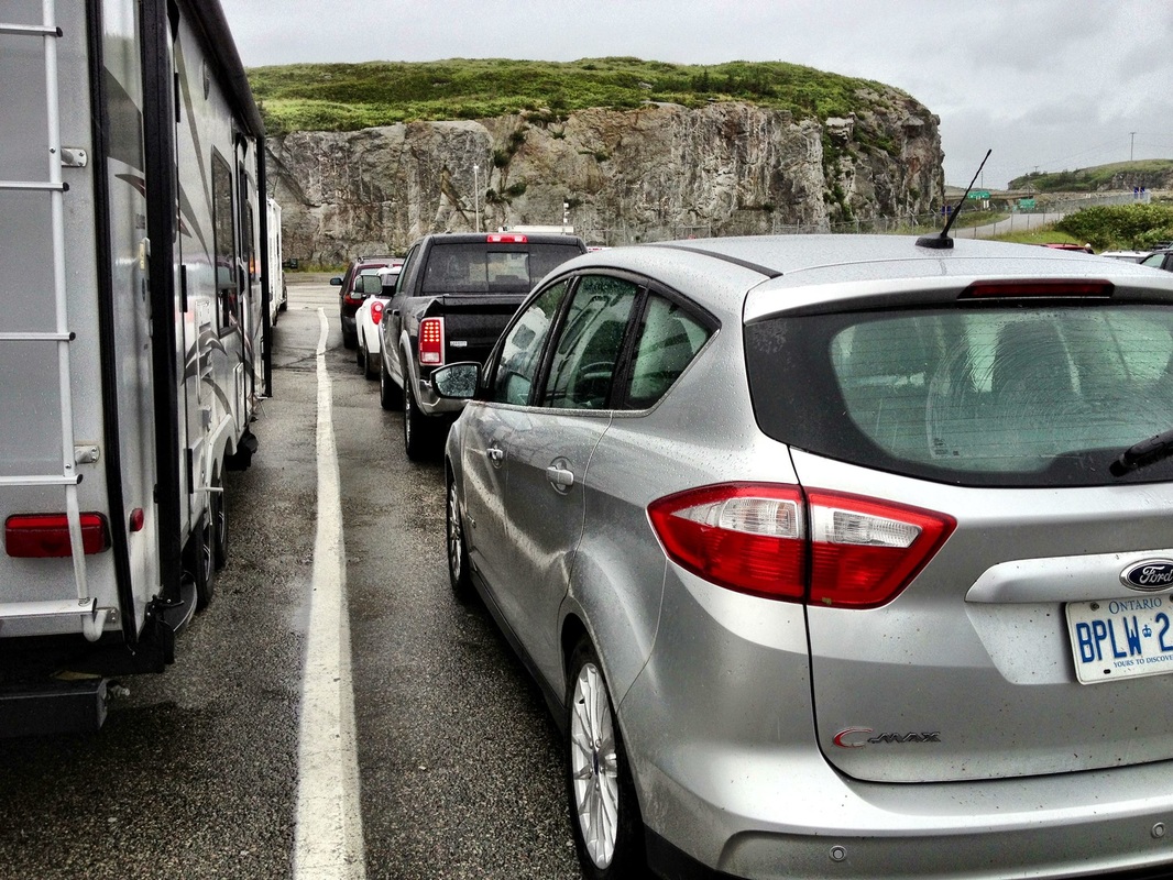 Cars and RVs lined up to get on the Newfoundland ferry on a rainy day