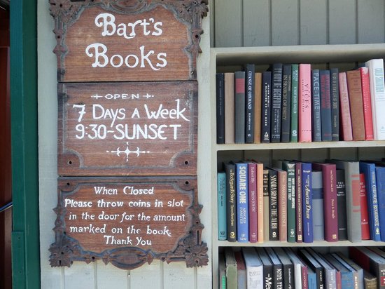 Close up of the exterior sign of Bart's Books beside a bookshelf Picture