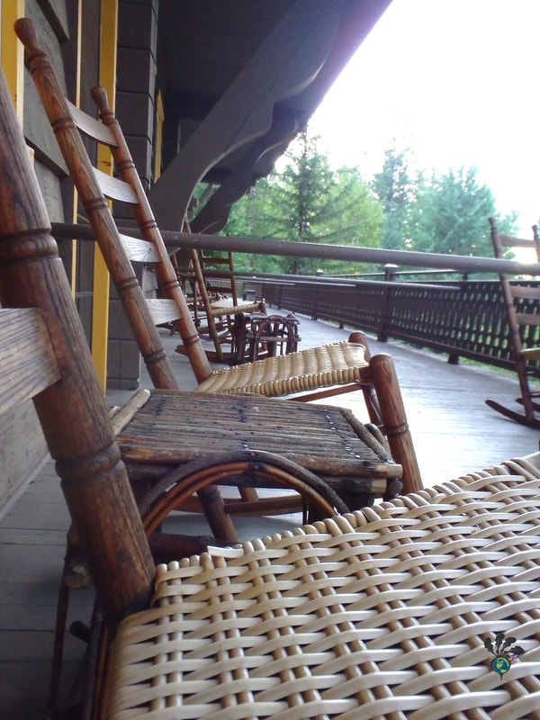 Wood and wicker chairs on the veranda of the Belton Chalet hotelPicture