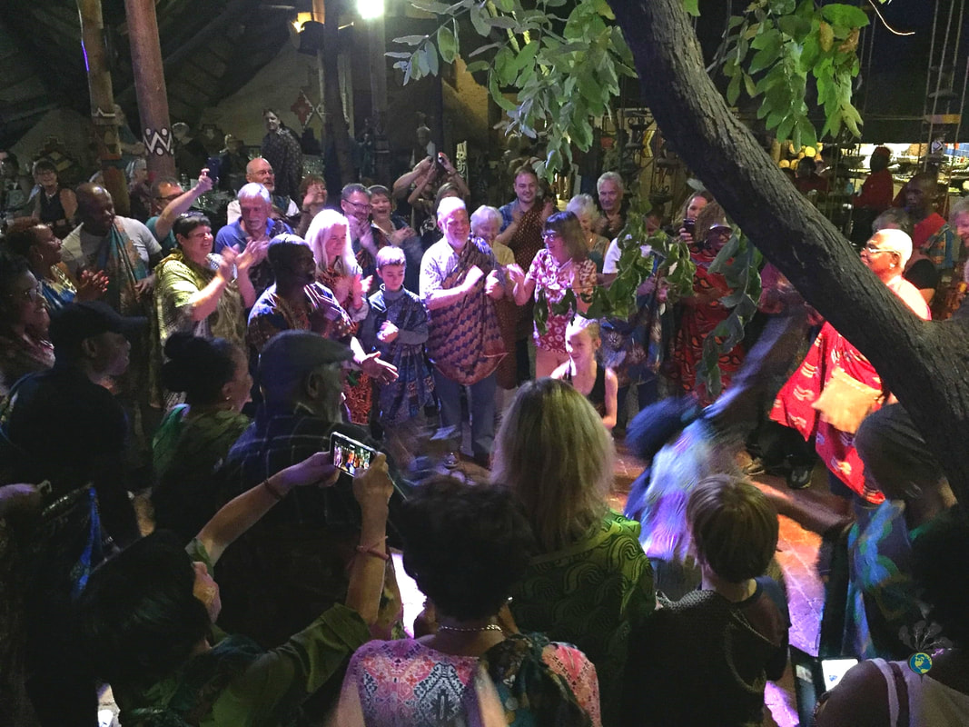 BOMA Victoria Falls buffet and drumming show: Tourists gathered in a circle to watch a drummer