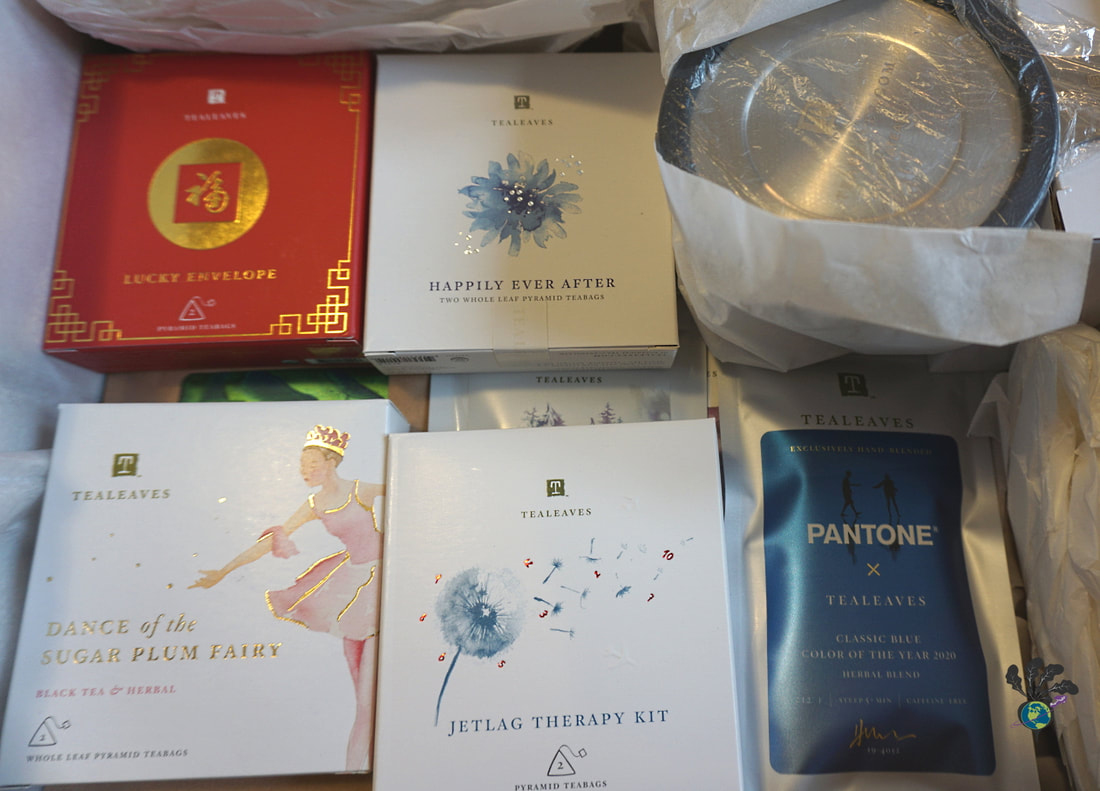 Different colorful sample size packages of tea sit in a box