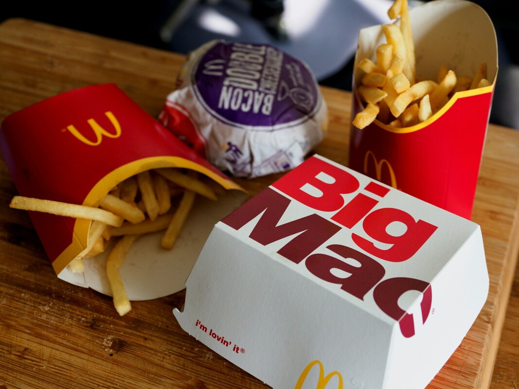 Photo of a Big Mac takeout box, two cartons of fries, and another burger wrapped in take out paper Picture