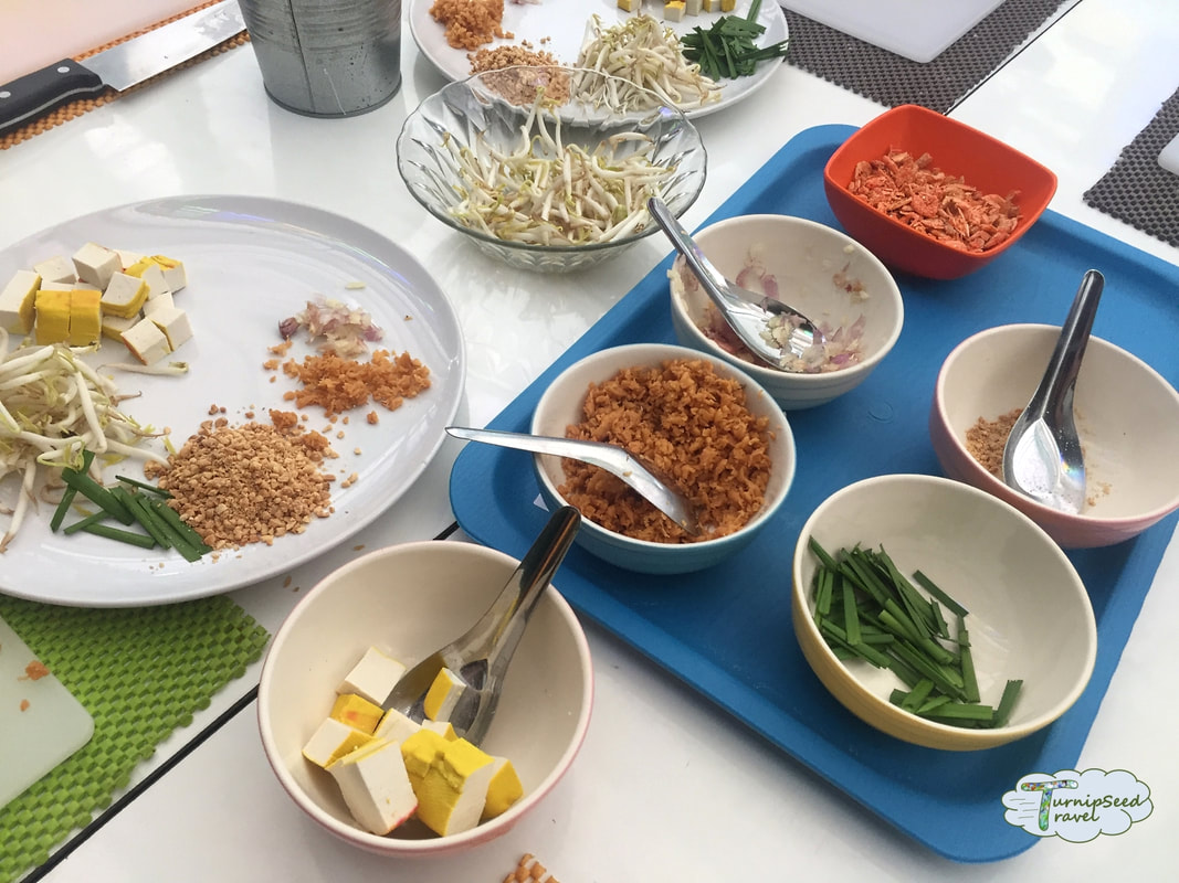 Bowls of prepared ingredients for making pad Thai 