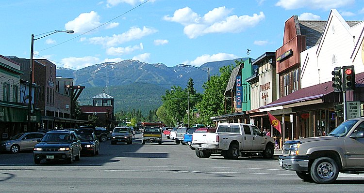 Things to do in Whitefish Montana: Wooden shops on mainstreet with the mountains in the distance.Picture