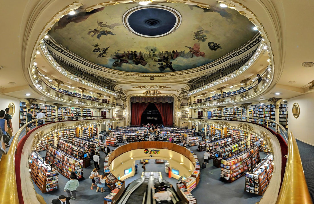 Panoramic shot of the interior of the El Ateno bookstore with lit balconies and rows of bookshelves Picture