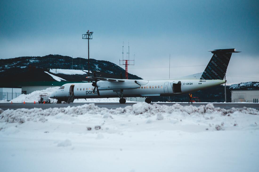 Canadian Transportation Agency Flight Delay Compensation Rules: Porter plane on a snowy airfield at dusk