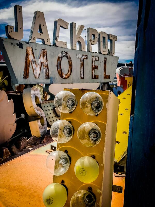 Old neon signs, including one for the Jackpot Motel