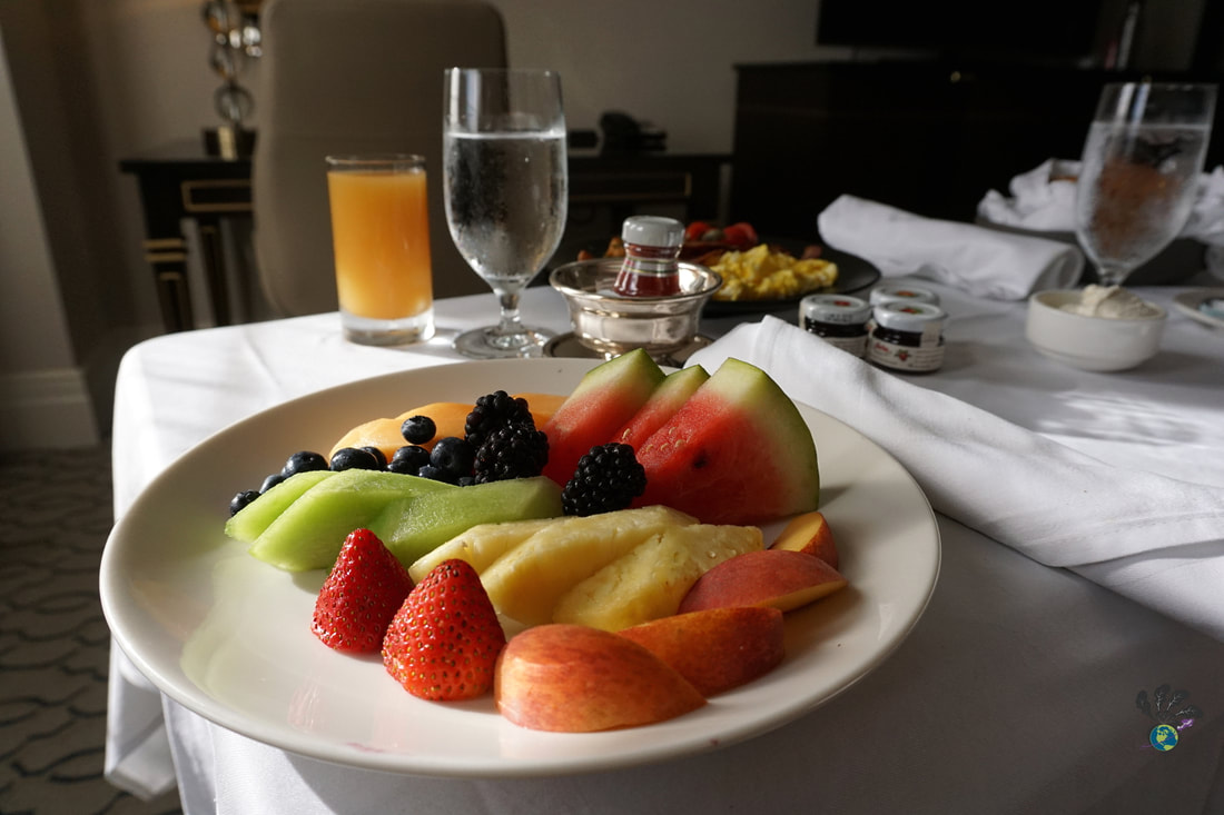 Room service tray with a plate of fresh fruit and berries on a white table clothPicture