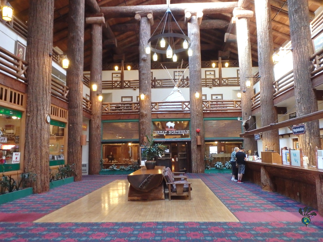 Hotel lobby with plaid carpet and high ceilings supported by giant logs Glacier Distilling and the Glacier Park Lodge's Great Northern Dining RoomPicture