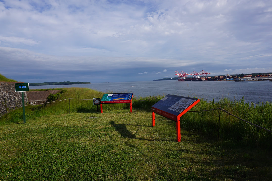 Informative plaques and a view of Halifax Harbour from Georges Island National Historic Site.