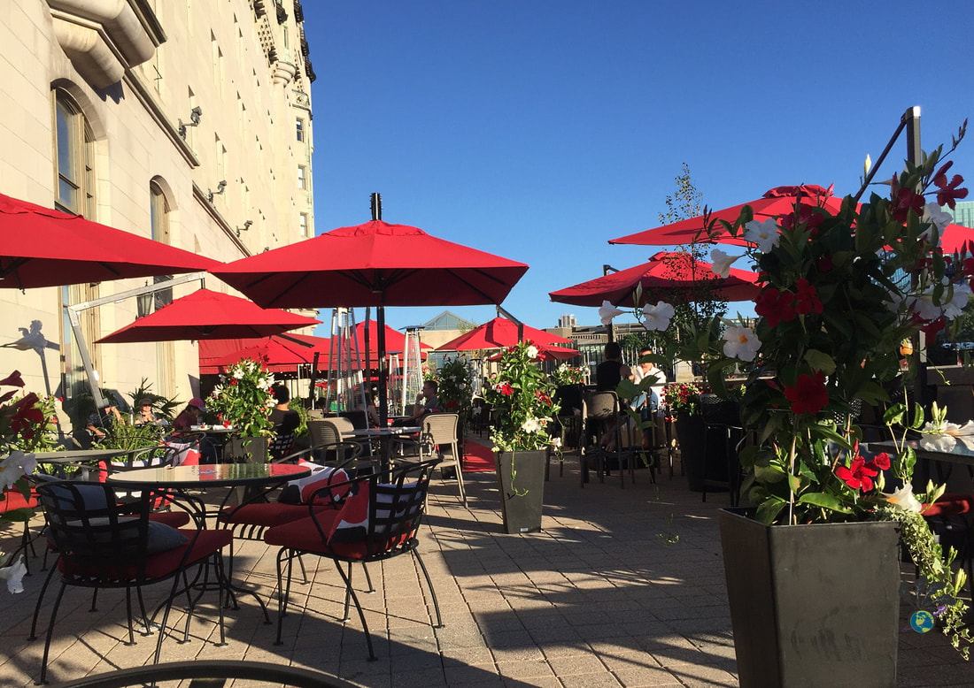 Red umbrellas and flower planters at La Terrace Picture