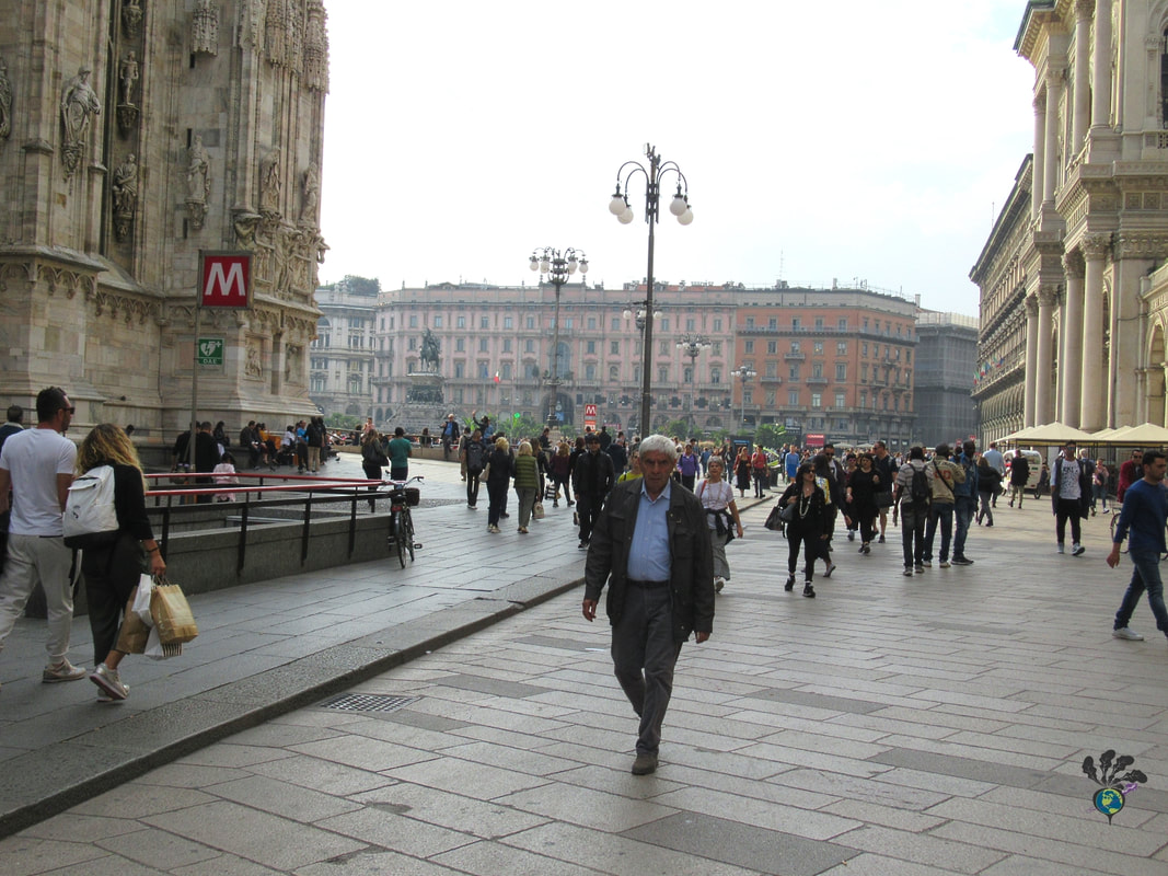 People walking on a wide pedestrian street next to the Milan Duomo Picture