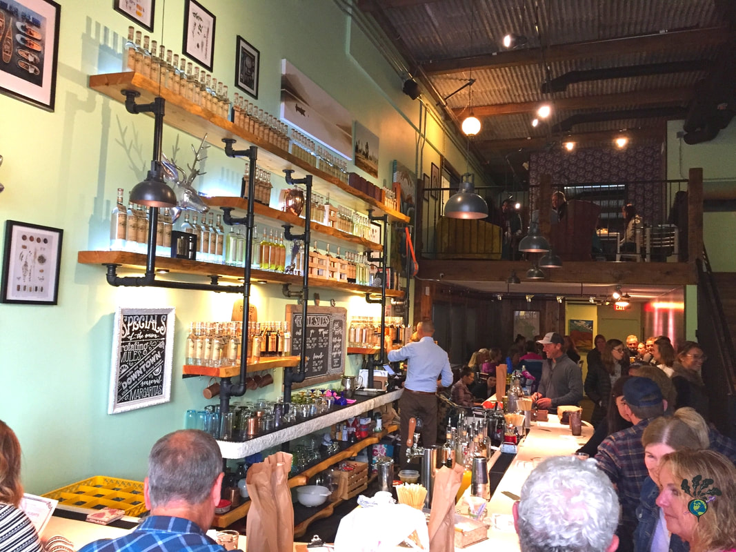 Spotted bear spirits whitefish montana: Inside of the bar at the tasting room with lots of people crowded inPicture