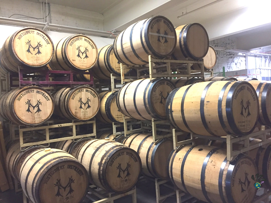 Stacked wooden barrels of spirits at Montgomery DistilleryPicture