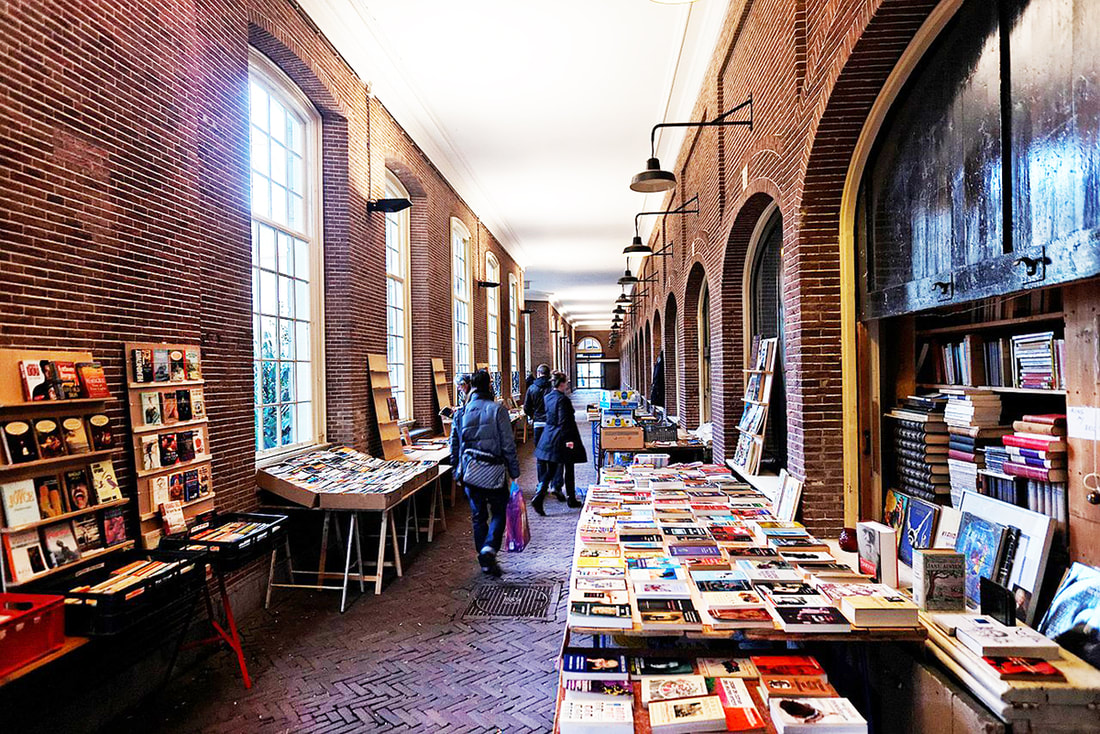 interior courtyard of a bookstore with multiple rounded arches and red brick walls Picture