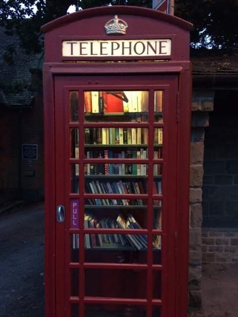 Red British phone booth transformed into a book exchangePicture