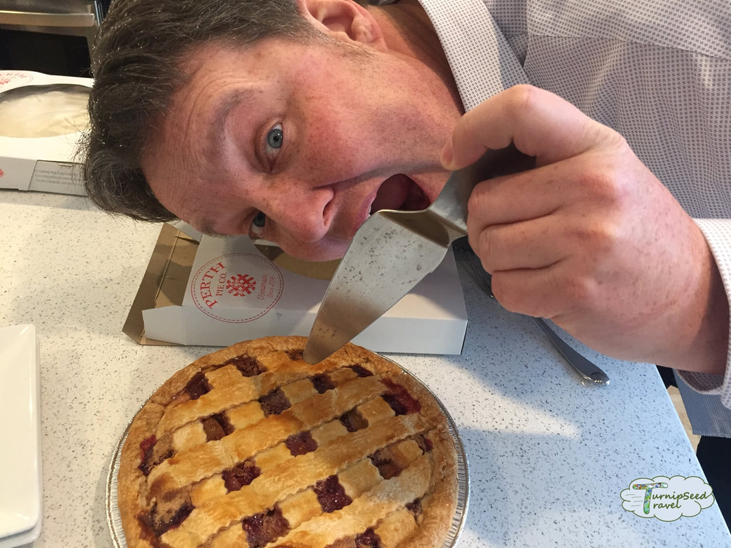 Ryan poses with a raspberry peach pie