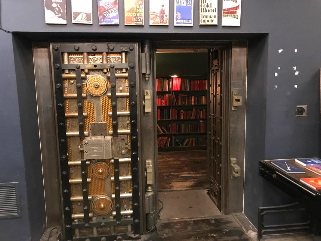 Walk in vault containing a shelf of red books Picture