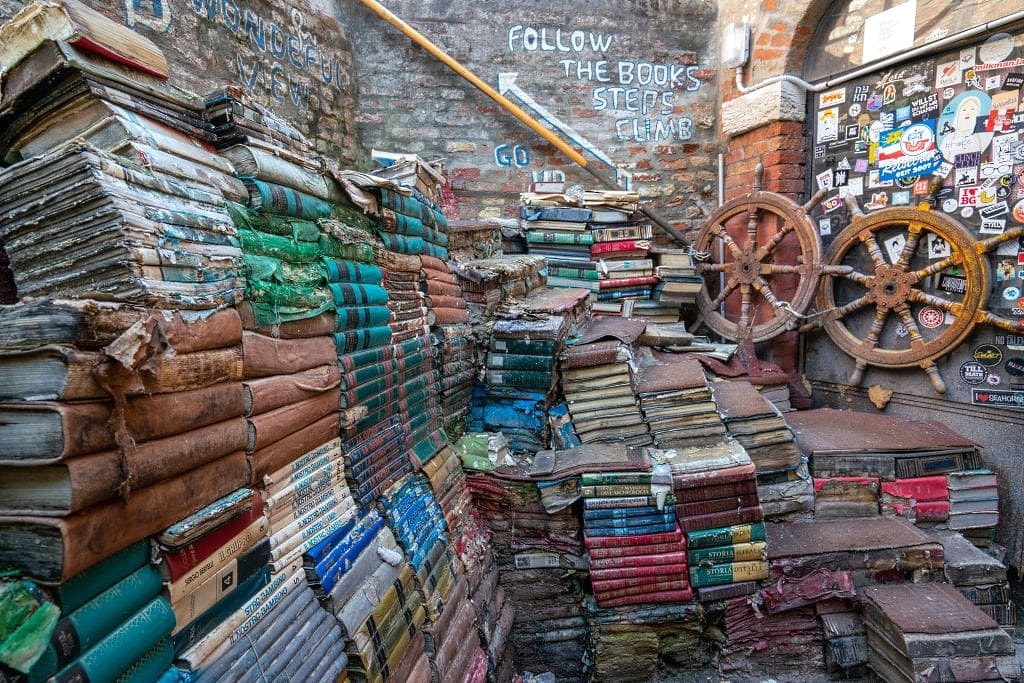 Stacks of old damaged books set up to form a staircase in Venice
