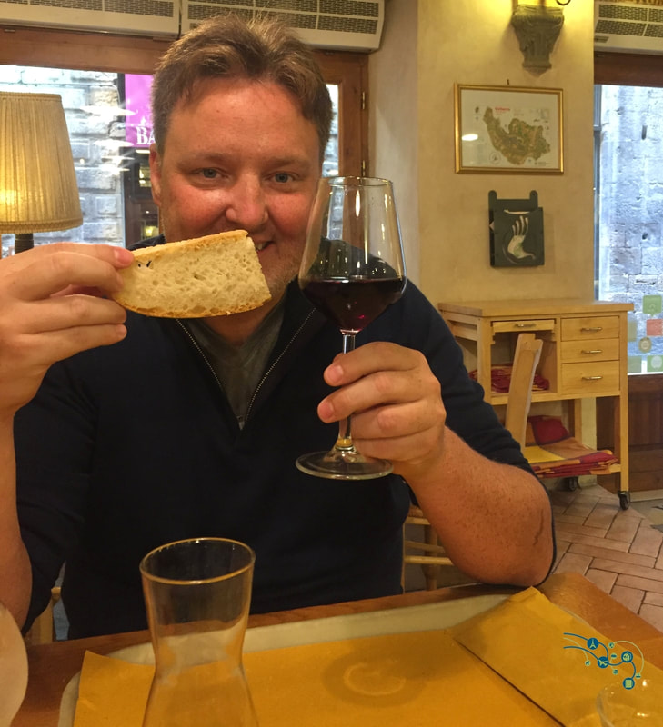 Ryan poses with wine and bread at an Orvieto winery