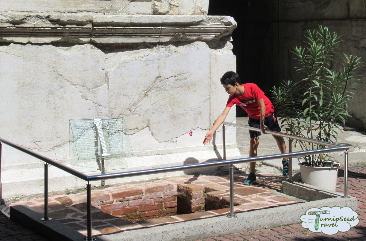 Boy at wishing well of Roman Stadium - one of the best things to do in Plovdiv Picture
