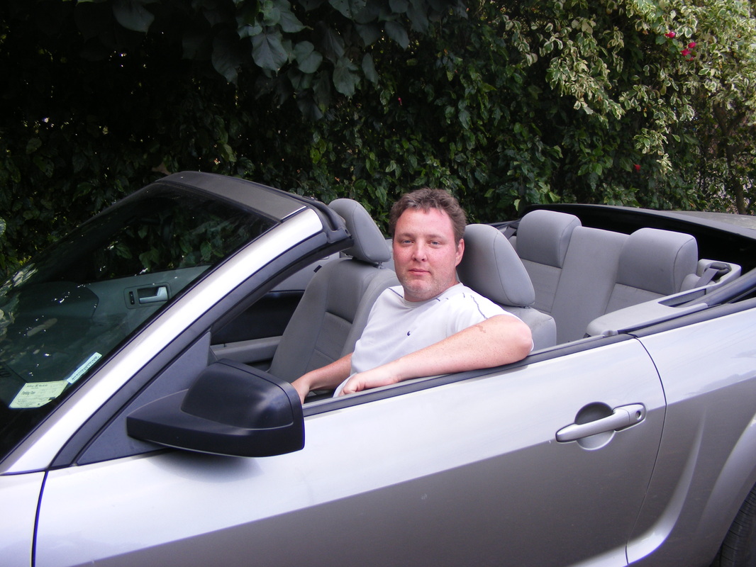 Car rental tips and tricks: Ryan in a silver convertible 
