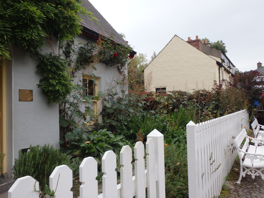 Small cottage and white picket fence in Ireland