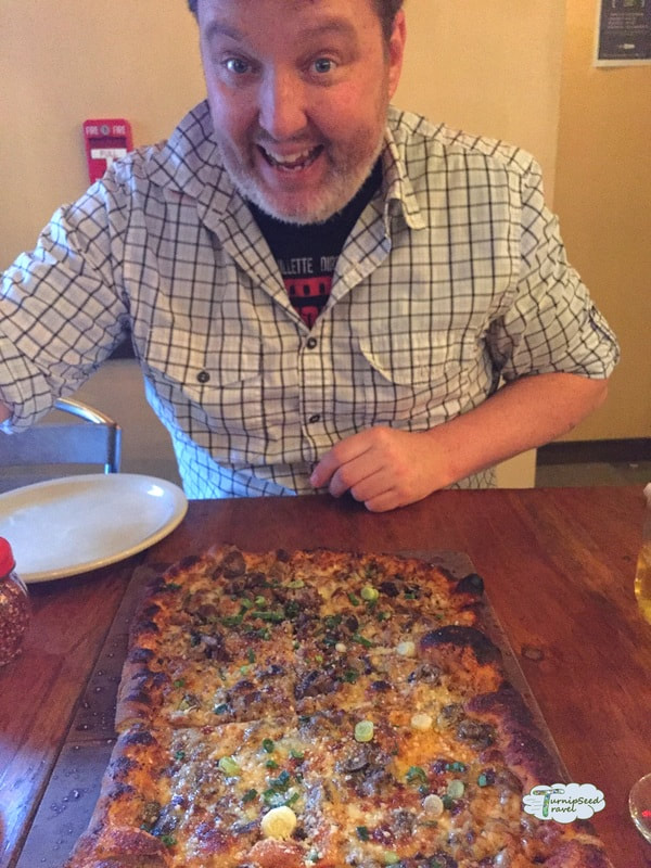 Ryan is excited by the giant square pizza Picture