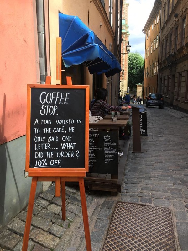 Coffee shop sign on cobblestones Picture