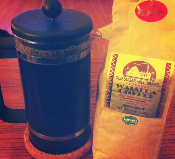 French press filled with coffee and a bag of Hawaiian coffee beans Picture
