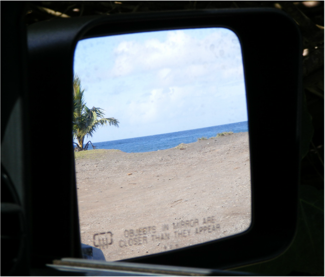 View of the beach from the car mirror