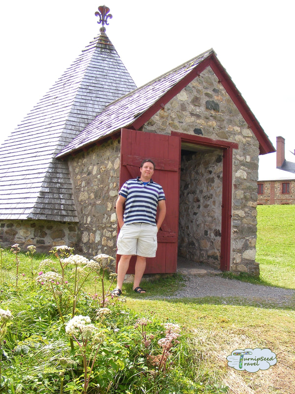 Touring Fortress Louisbourg - Ryan stands by a stone building