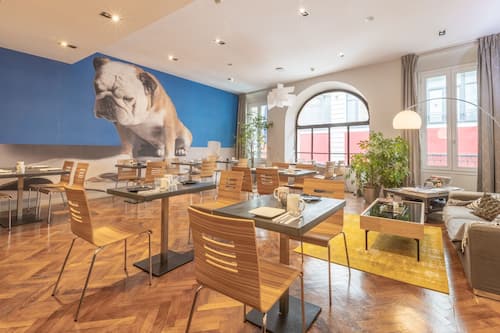 Sunny breakfast room showing a mural of a bulldog on one wall