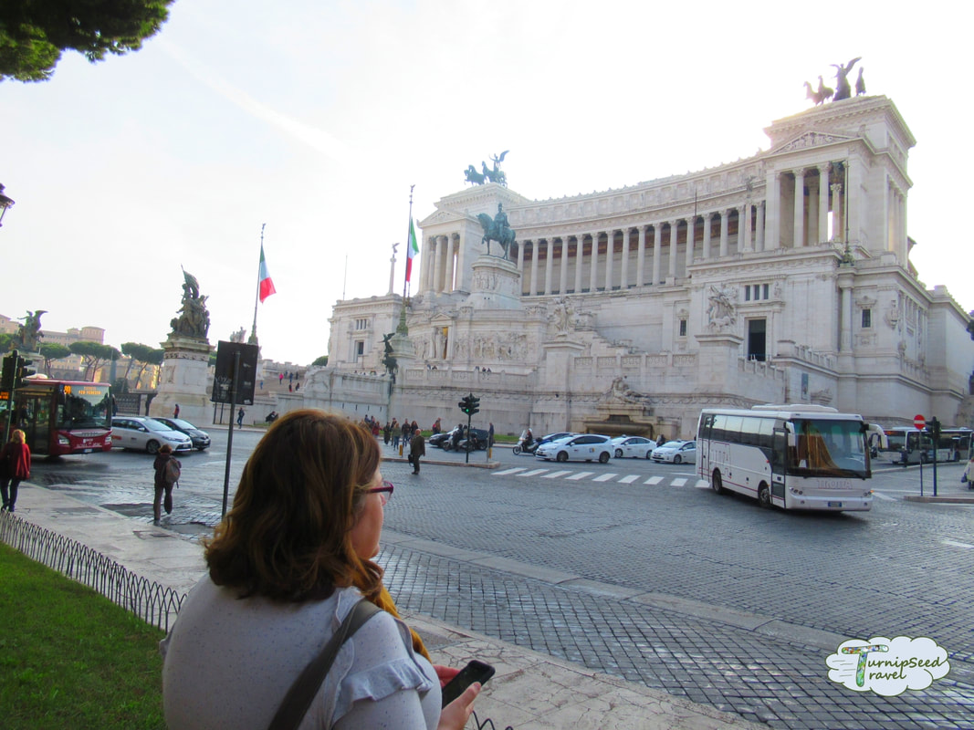 Vanessa looks at an ancient stone monument and Roman traffic Picture