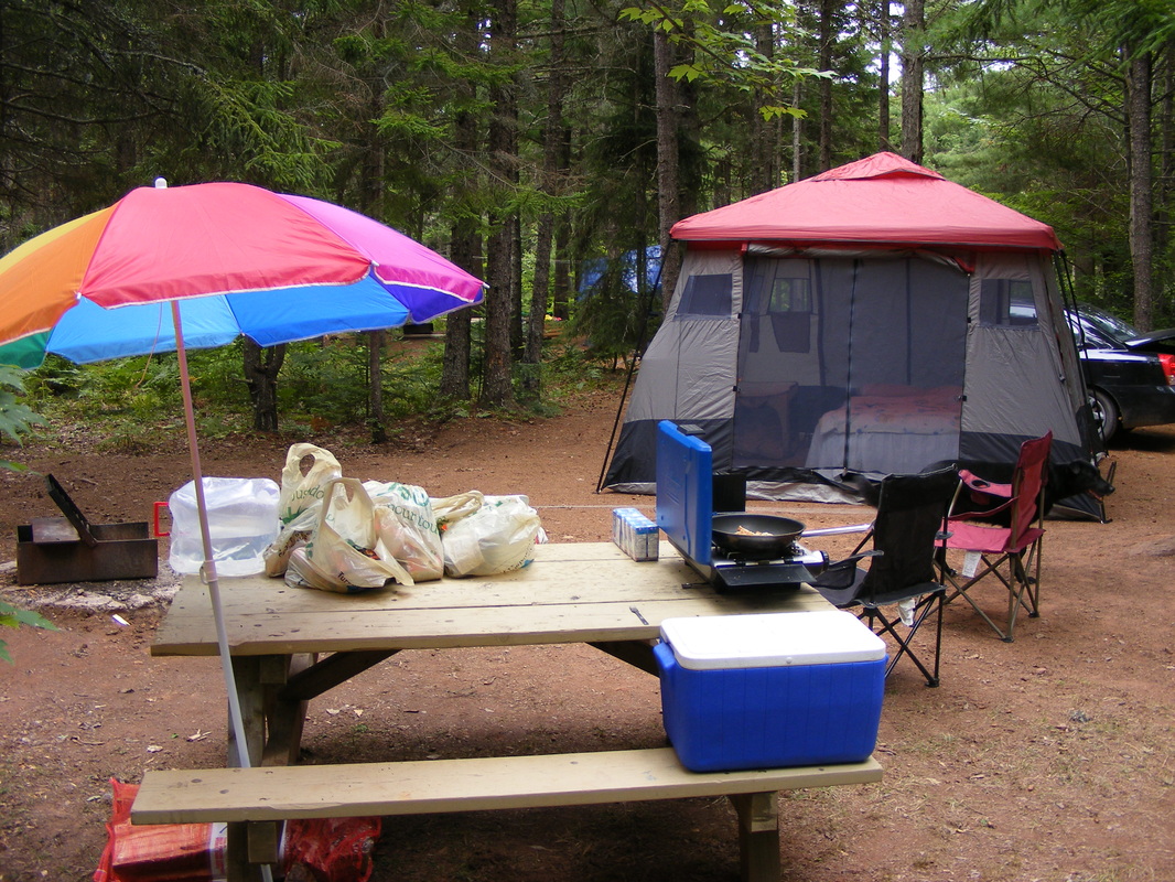 Campground set up with tent and picnic table 