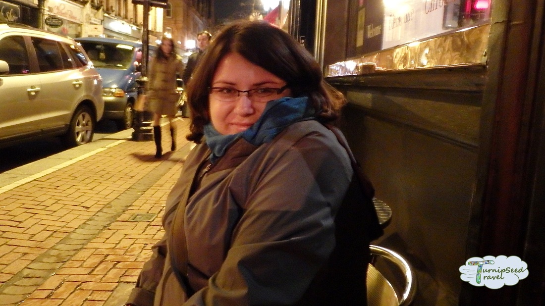 Vanessa at a sidewalk table in Dublin at dusk