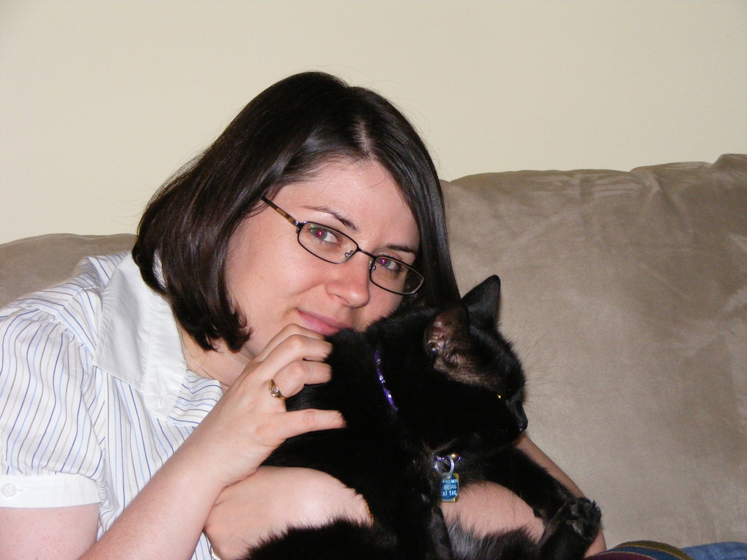 Vanessa holds Darwyn, a black fluffy cat