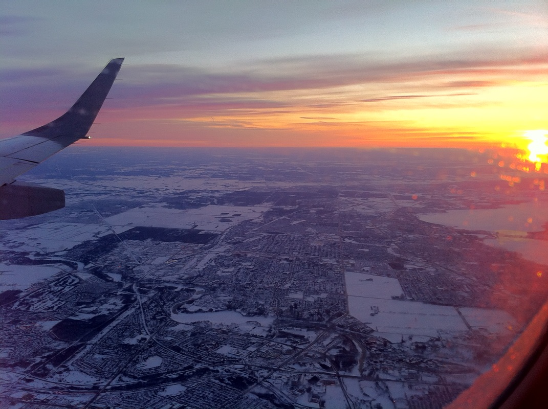 View from an airplane window of snowy fieldsPicture