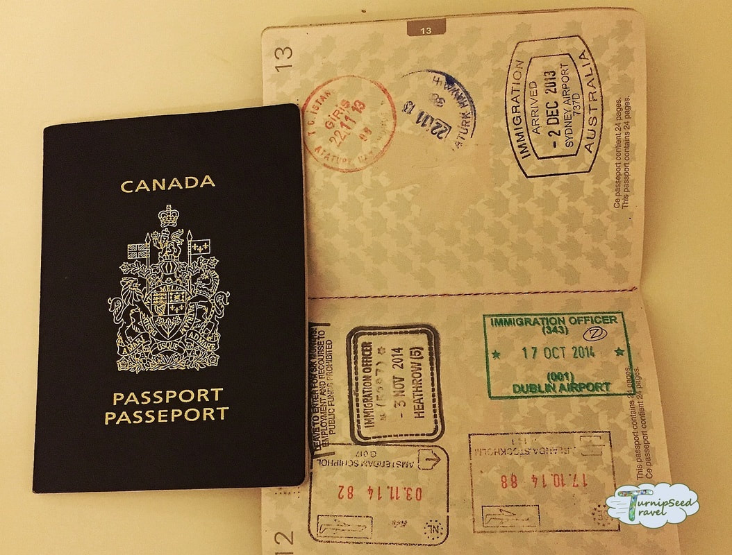 A Canadian passport and an open passport showing travel visas