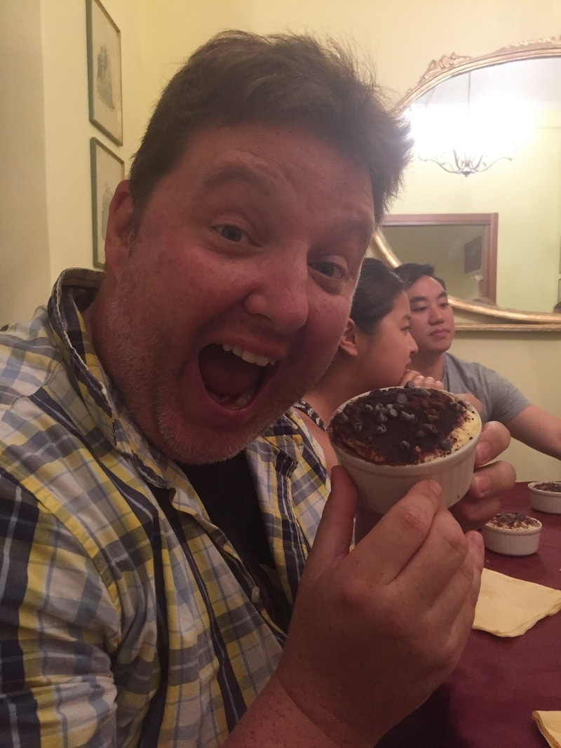 Ryan smiles and shows off his dish of Tiramisu 
