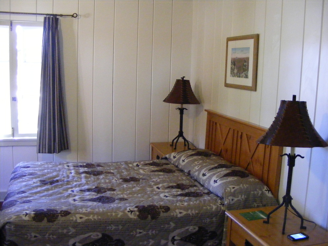 Bedroom at Bright Angle lodge with a grey flowered bed spread Picture