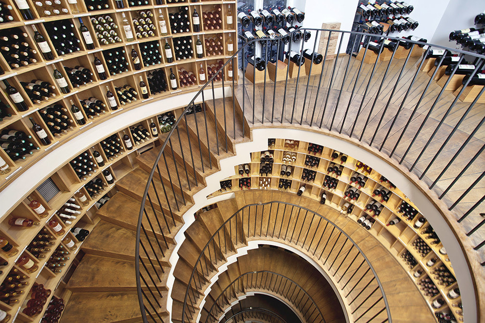 Spiral staircase lined with wine bottles