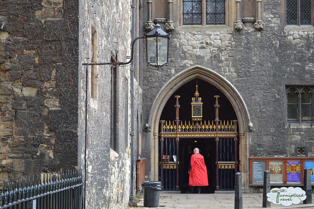 Best churches to visit in London: Clergy in red robes entering a side door of Westminster Abbey Picture